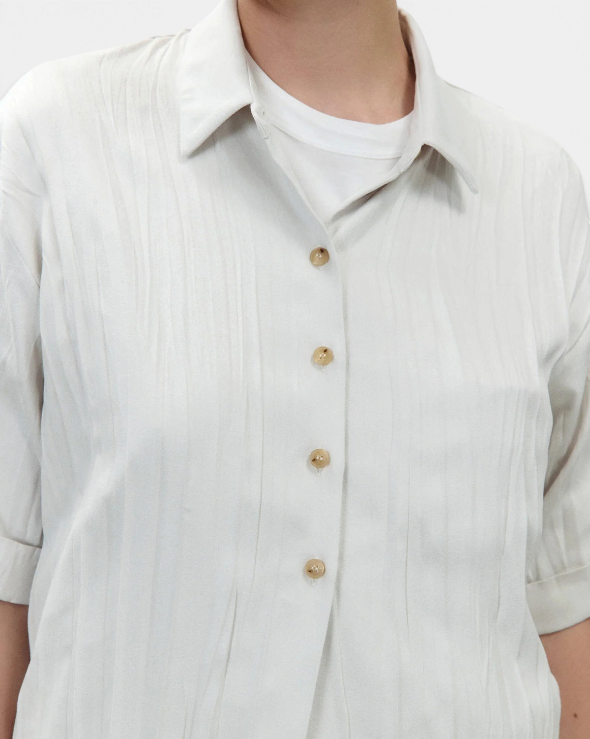 The Copper Shed Wrinkled Dainetto shirt in off-white faux suede with a crumpled texture, collar, and button-up front.