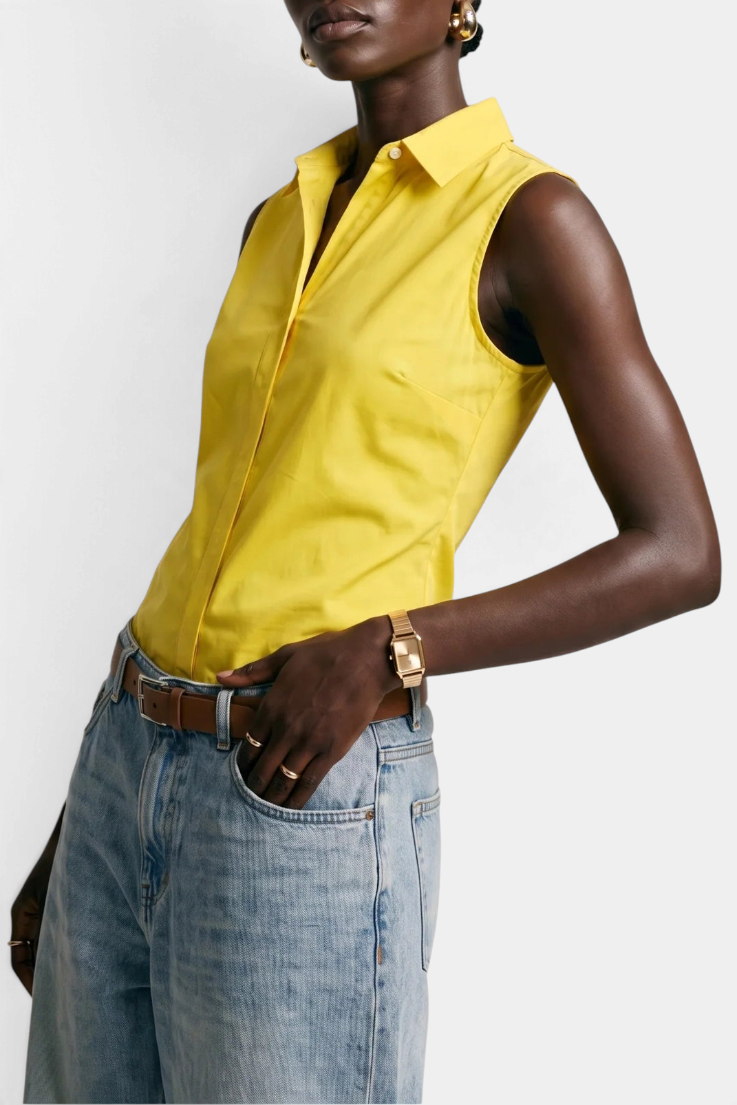 The Copper Shed yellow sleeveless cotton button-down shirt with No Gape technology worn with light wash jeans