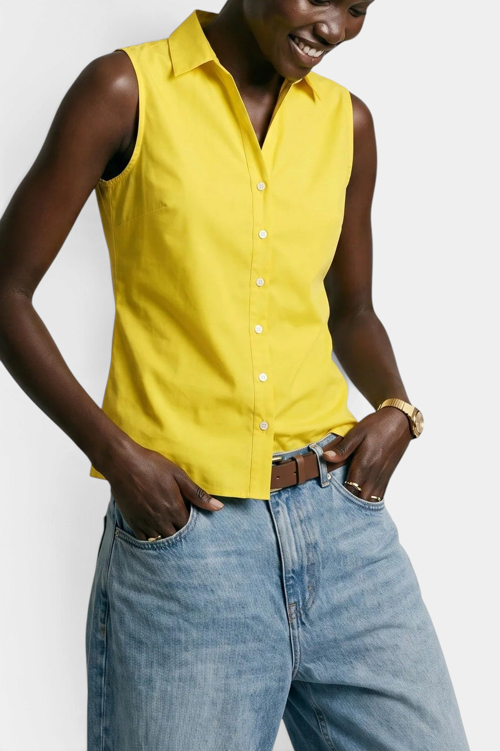 The Copper Shed yellow sleeveless cotton button-down shirt with No Gape technology worn by a model with blue jeans.