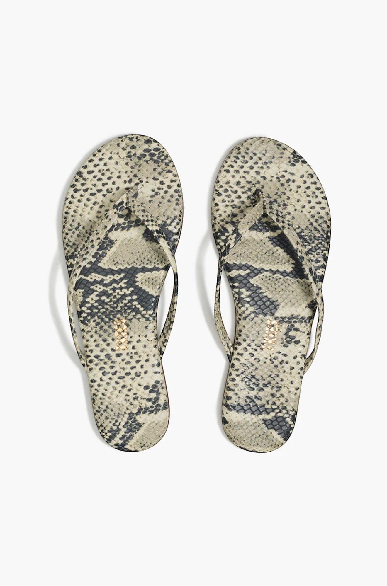 The Copper Shed neutral snake print flip flops with thong straps and flat soles.