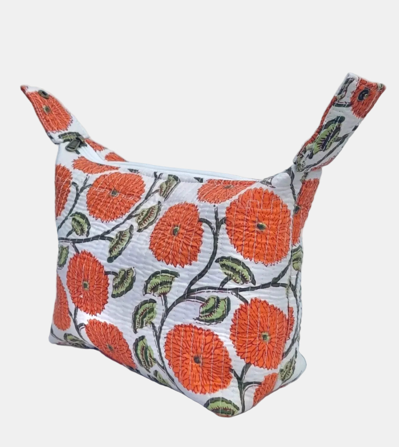 A small fabric zip pouch with a white background and a bold orange floral pattern with green leaves, featuring two top handles, set against a light gray textured backdrop.