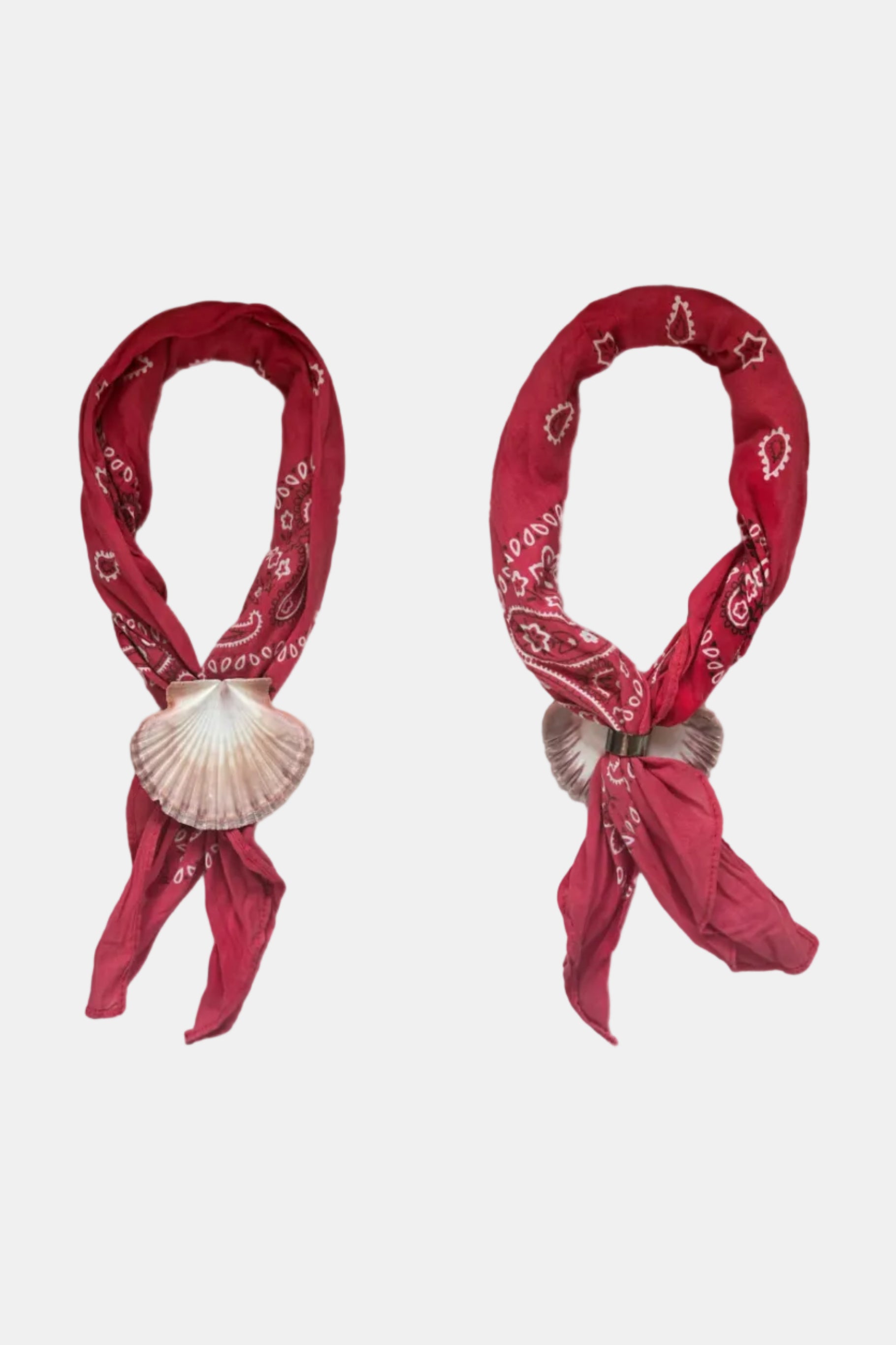 Two red bandanas with shell decorations on a white background