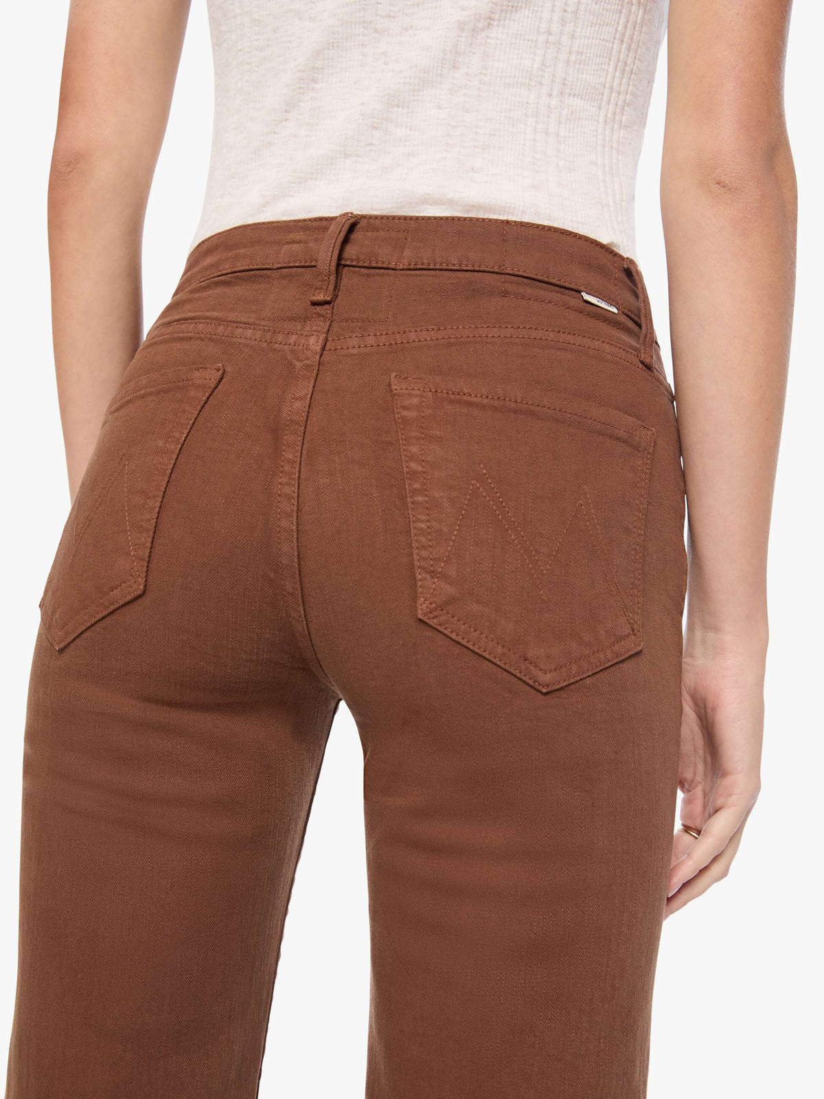 Brown pants worn by a person on a white background