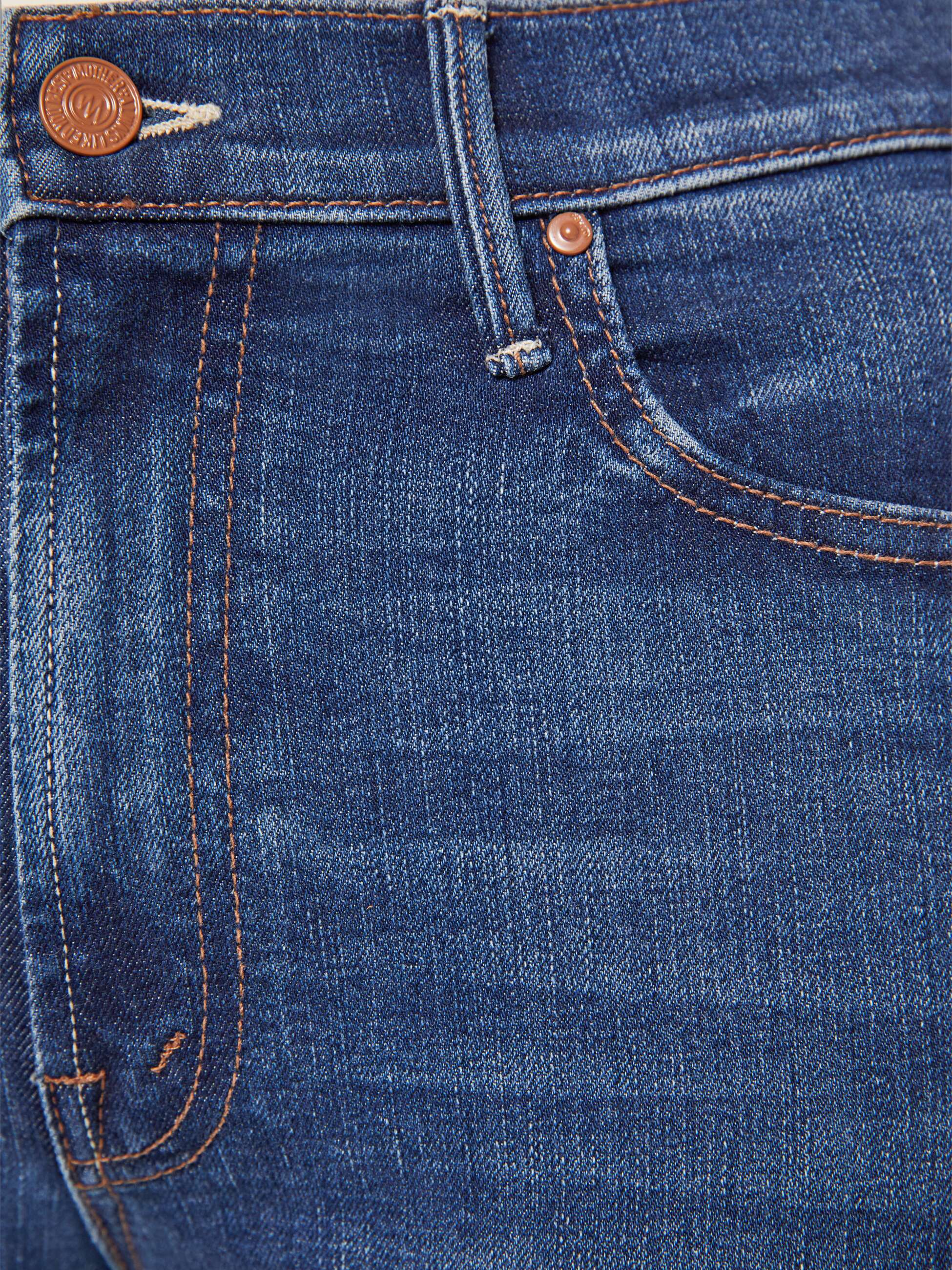 Close-up of blue denim fabric with stitching details