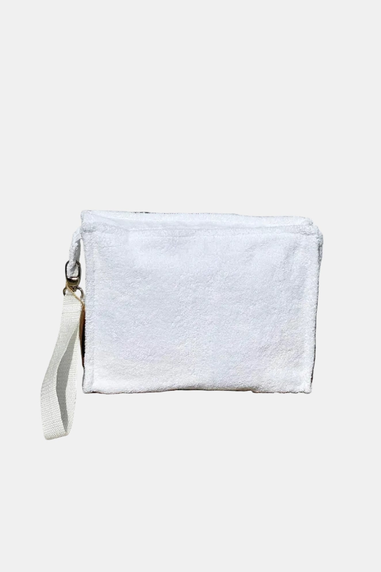 White clutch bag with a strap on a stone surface
