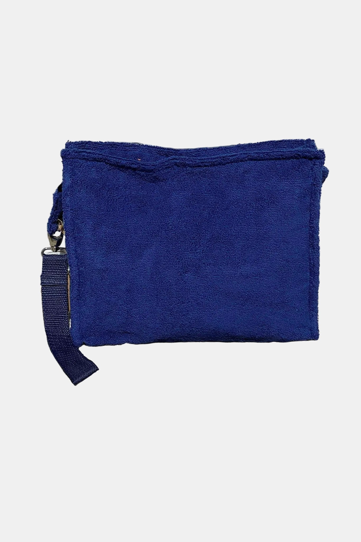 Blue pouch on a stone surface with a textured wall background