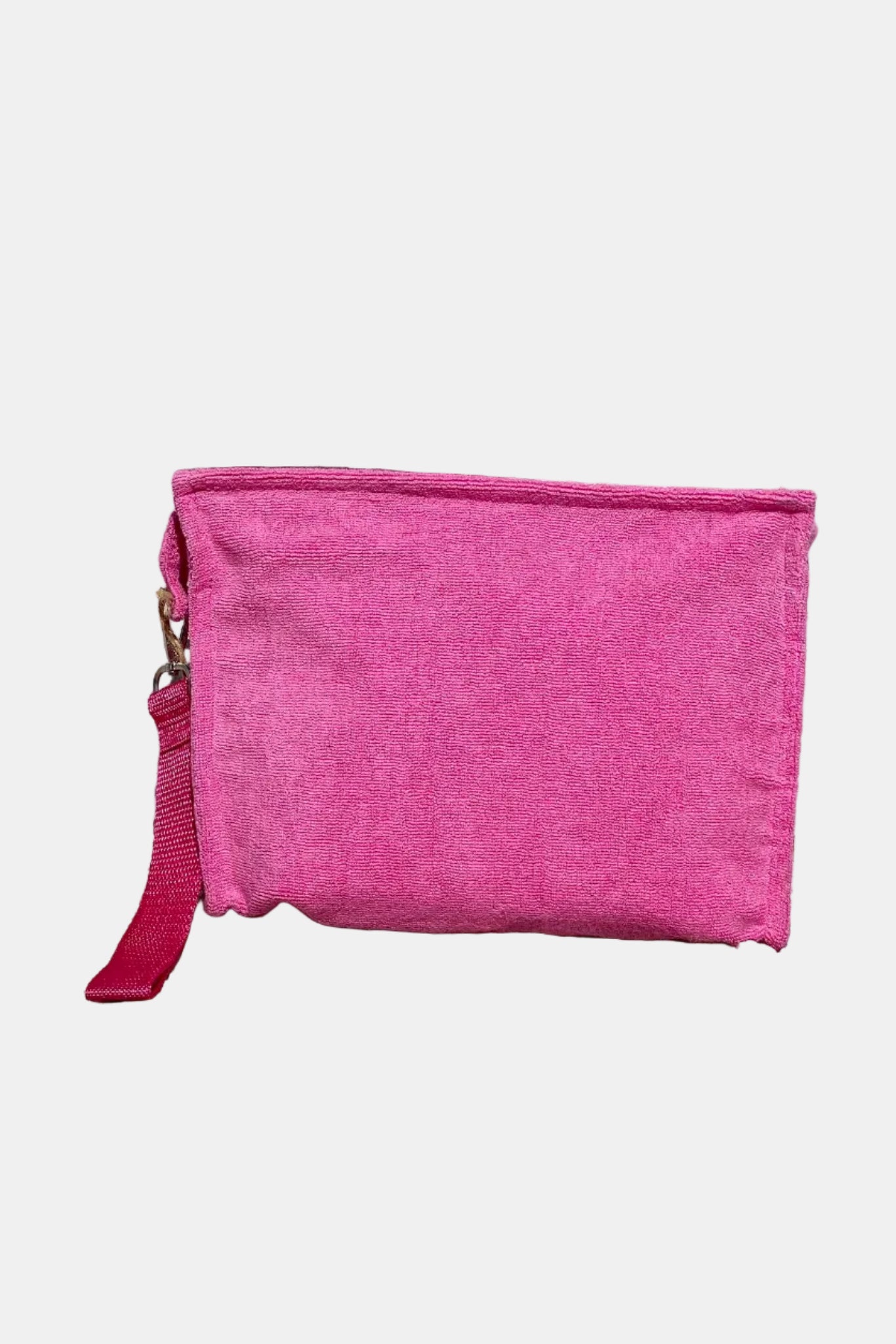 Pink pouch on a stone surface with a brick wall background
