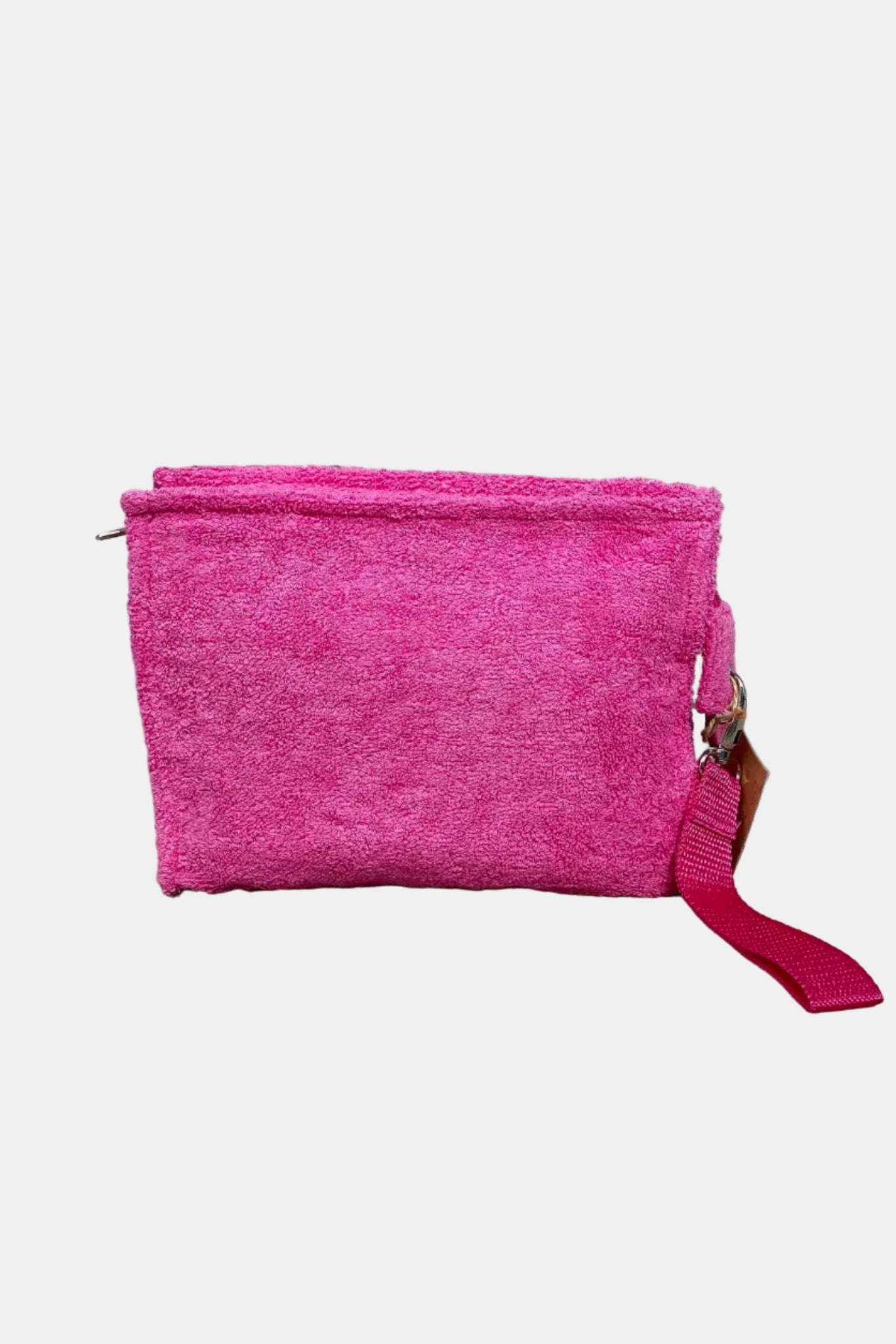 Pink pouch with a strap on a stone ground and stone wall background