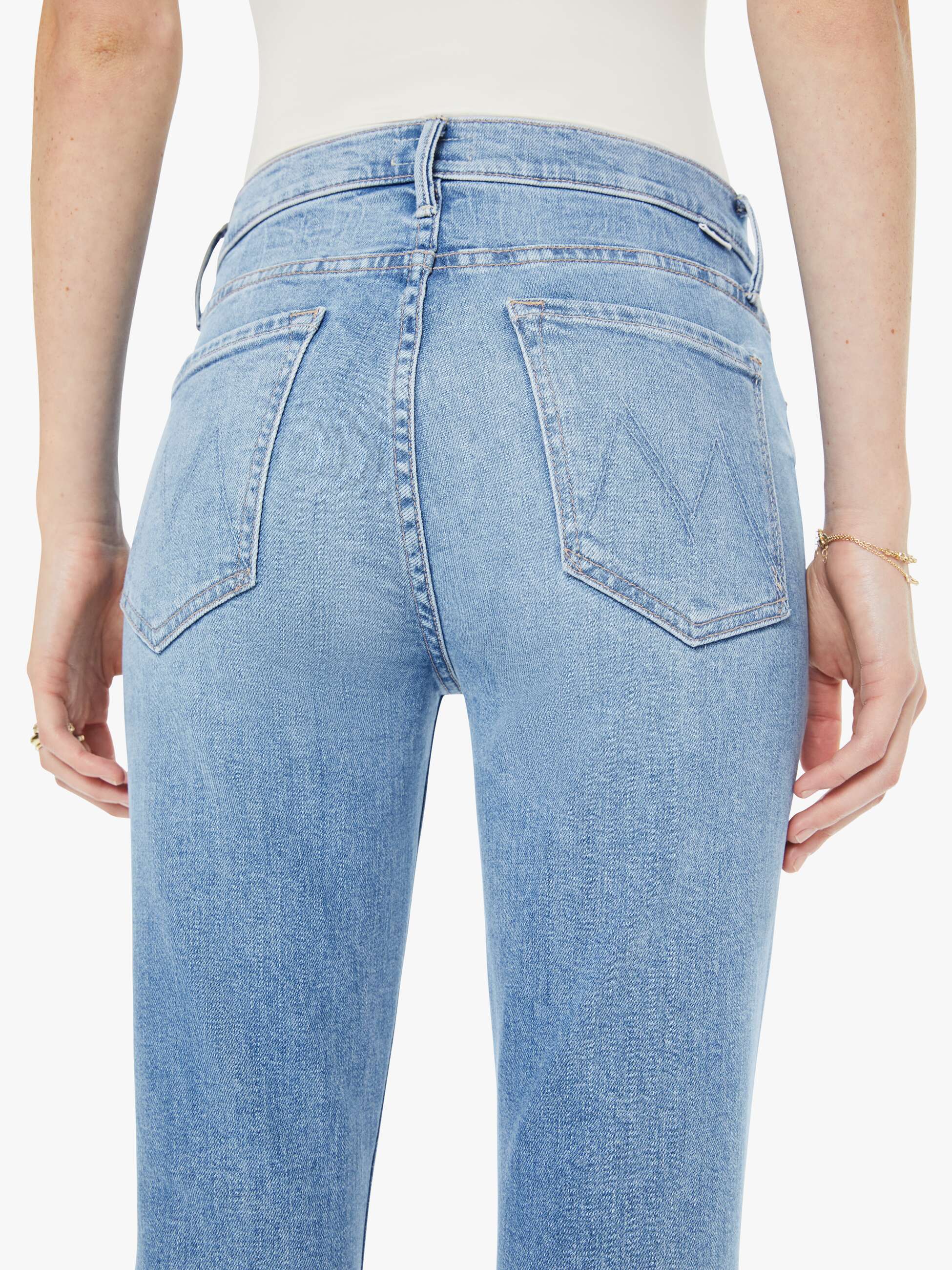 Light blue jeans worn by a person on a white background