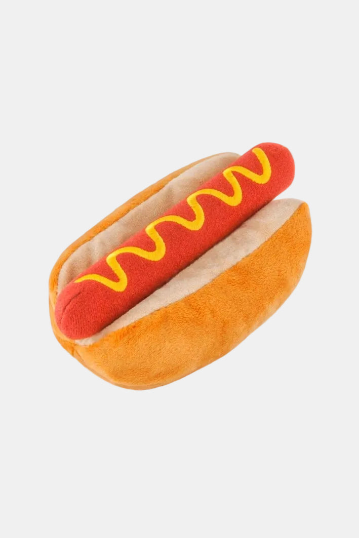Plush hot dog toy with mustard on a white background