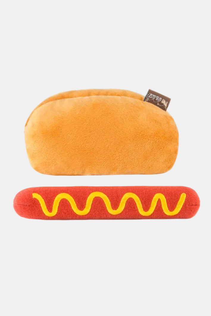 Plush hot dog toy with bun and sausage on a white background