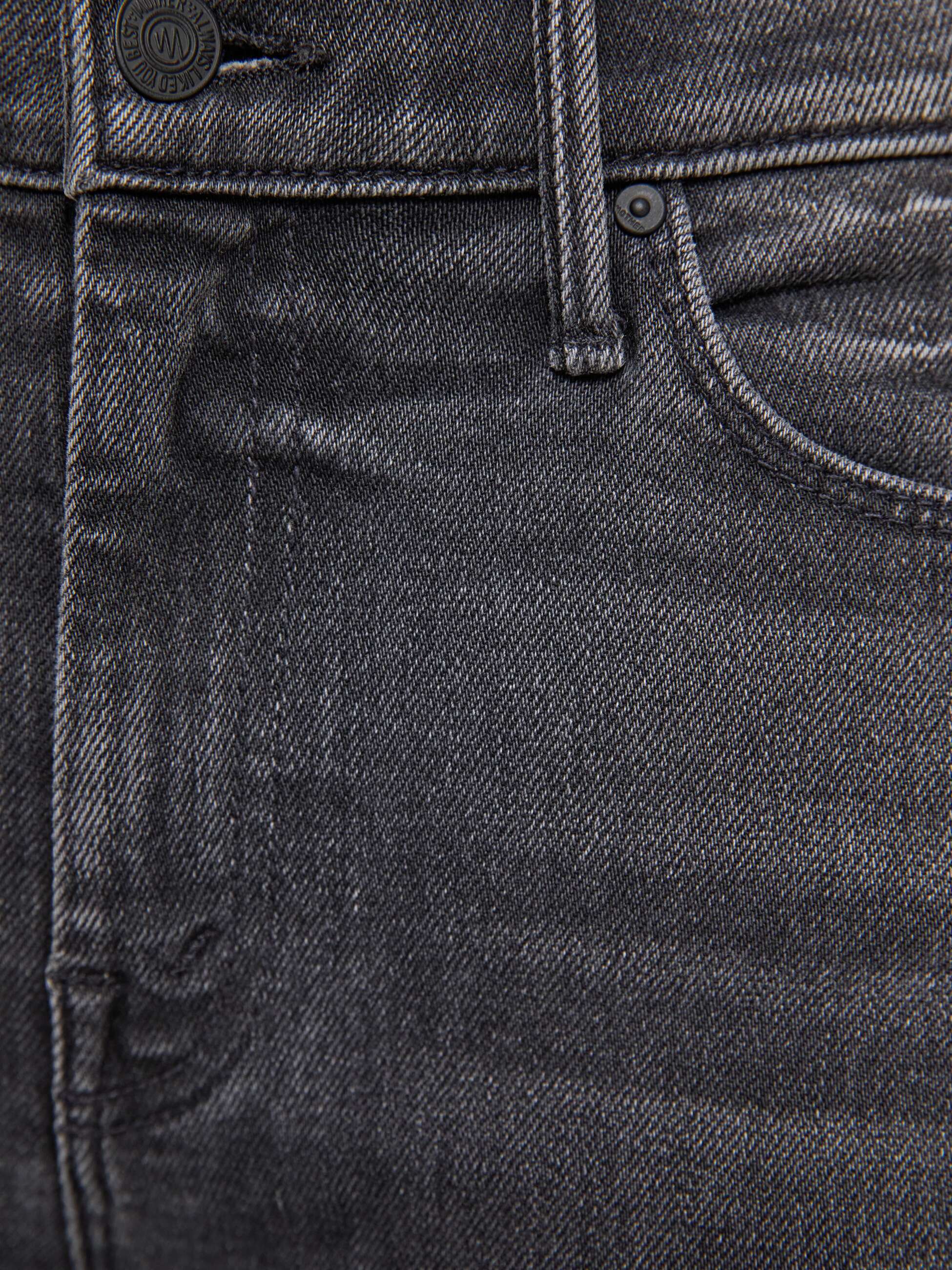 Close-up of dark gray jeans with stitching details