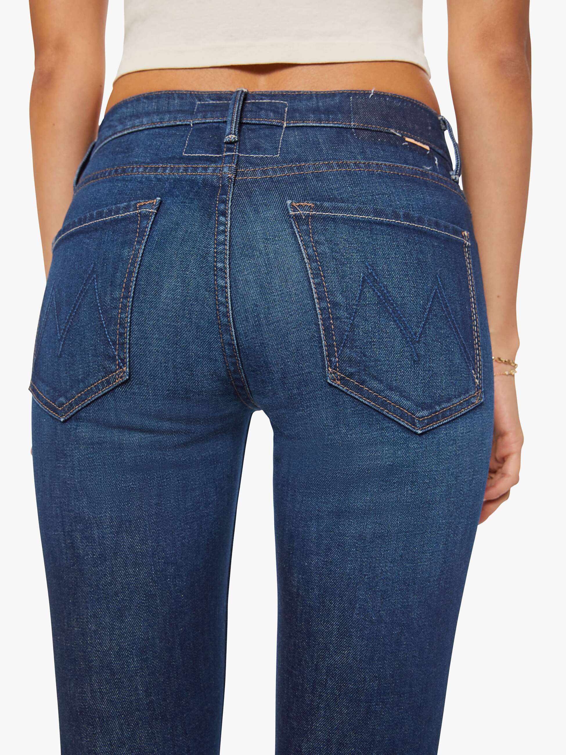 Blue jeans worn by a person on a white background