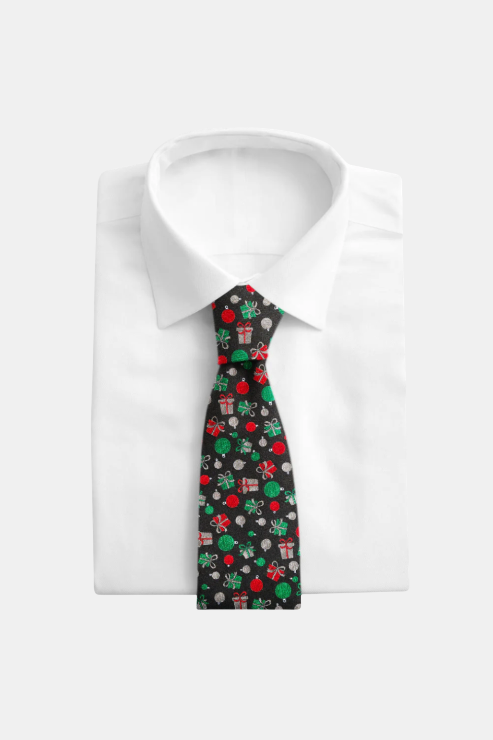 A green necktie with a fine micro-dot pattern, neatly tied and displayed on a folded white dress shirt against a light gray background.