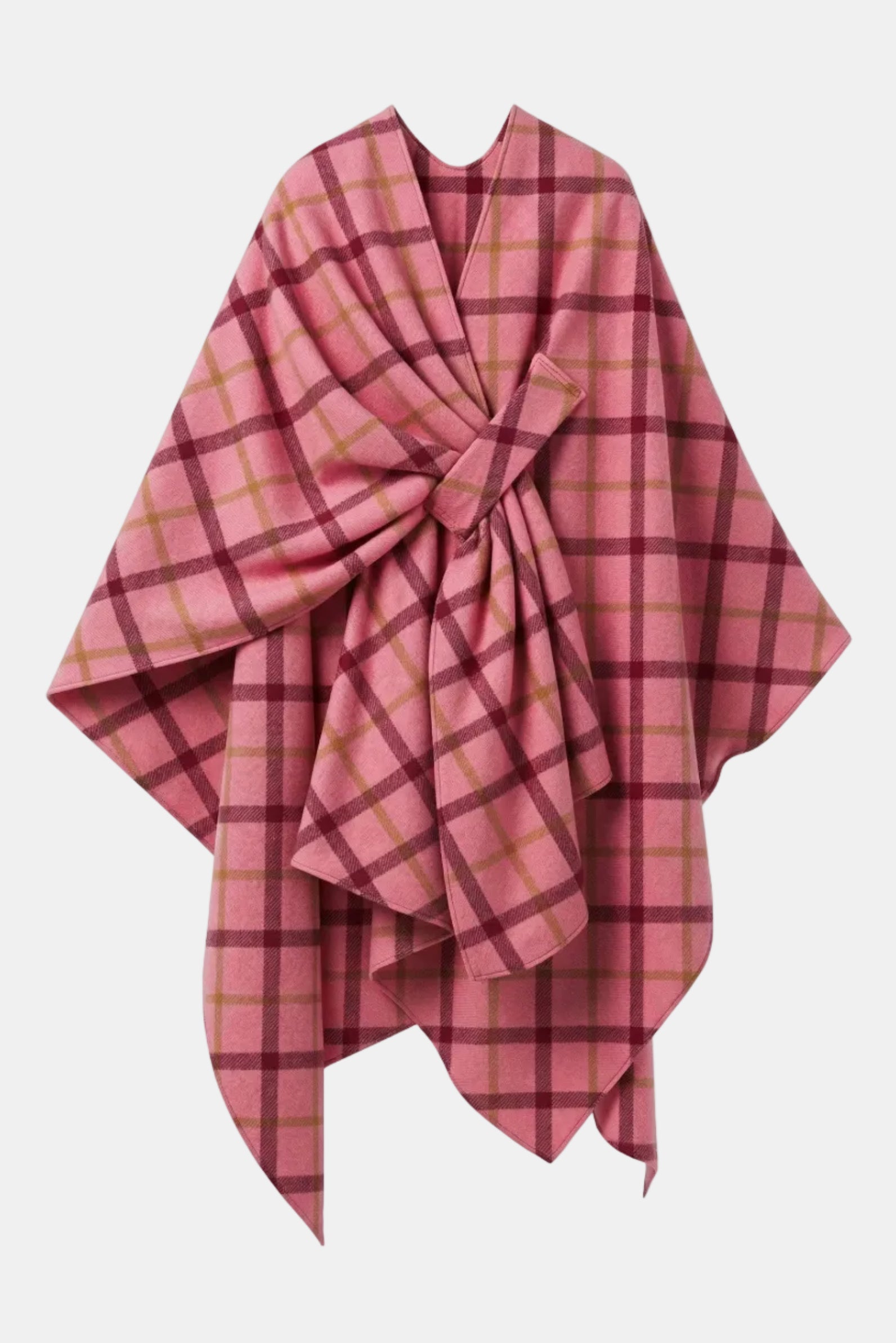 A pink plaid wrap poncho or shawl draped on a white mannequin torso, featuring a large twisted knot at the center and a plaid pattern in shades of pink, burgundy, and olive green.