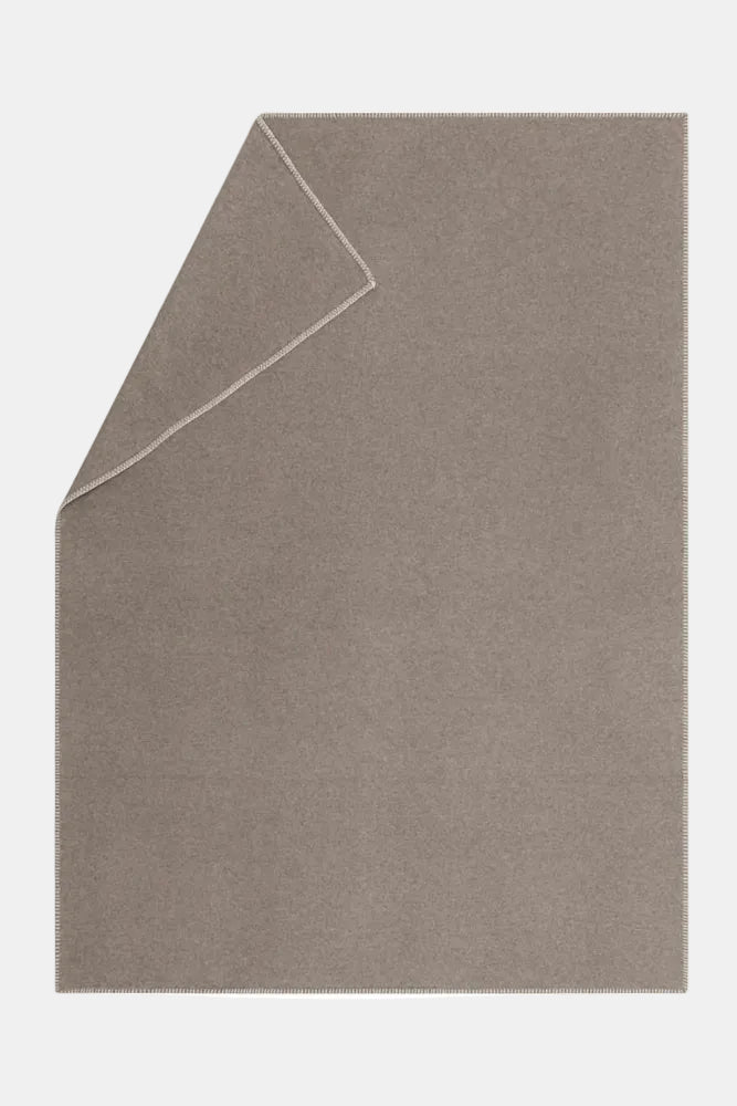 Brown blanket folded on a white background