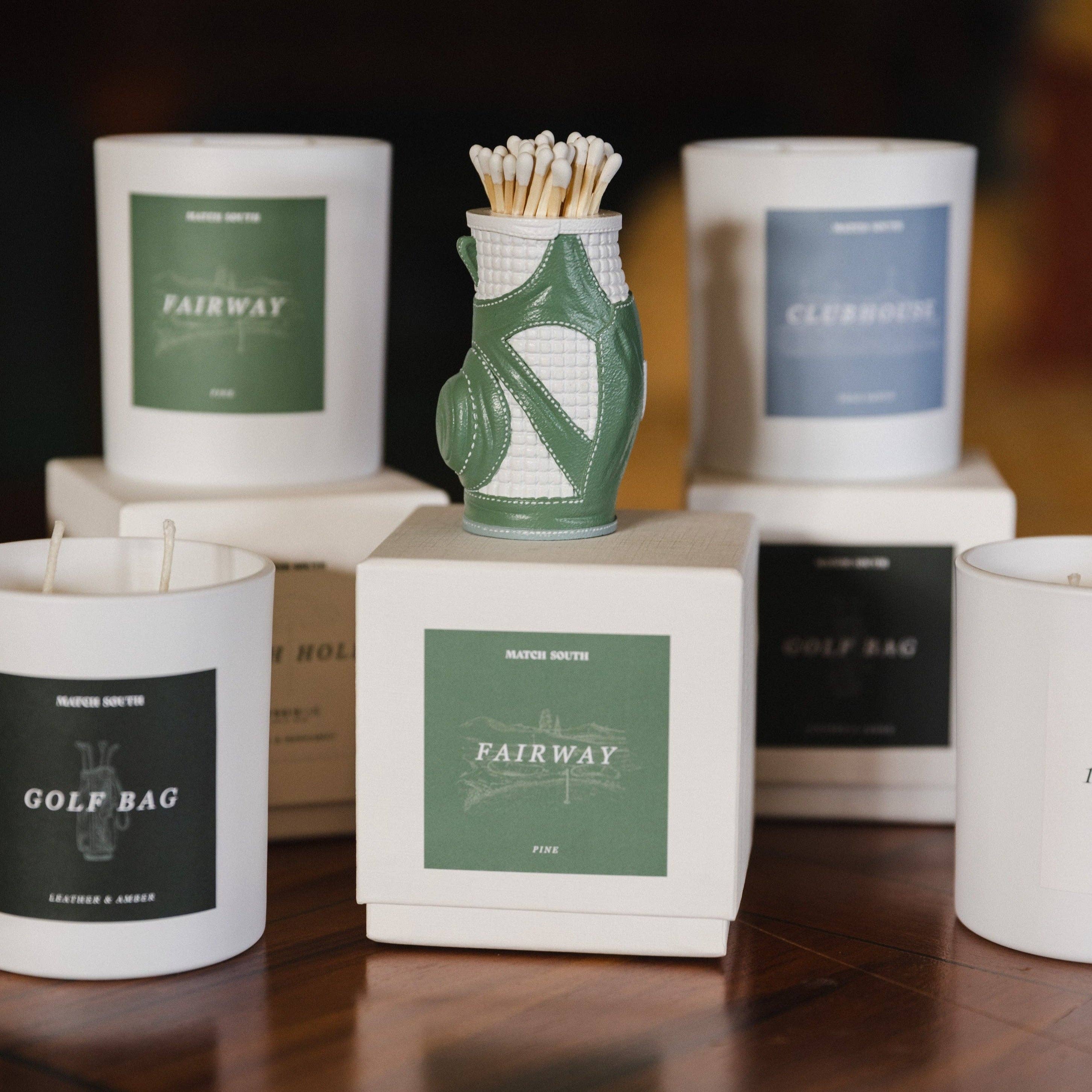 Matches in a golf bag-shaped container with 'Fairway' branded candles in the background.