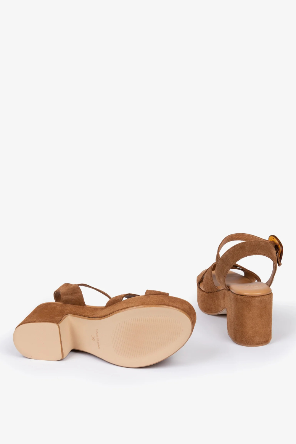 A pair of women's block-heel sandals in a warm tan suede-like material, shown from the side and back on a clean white studio background.