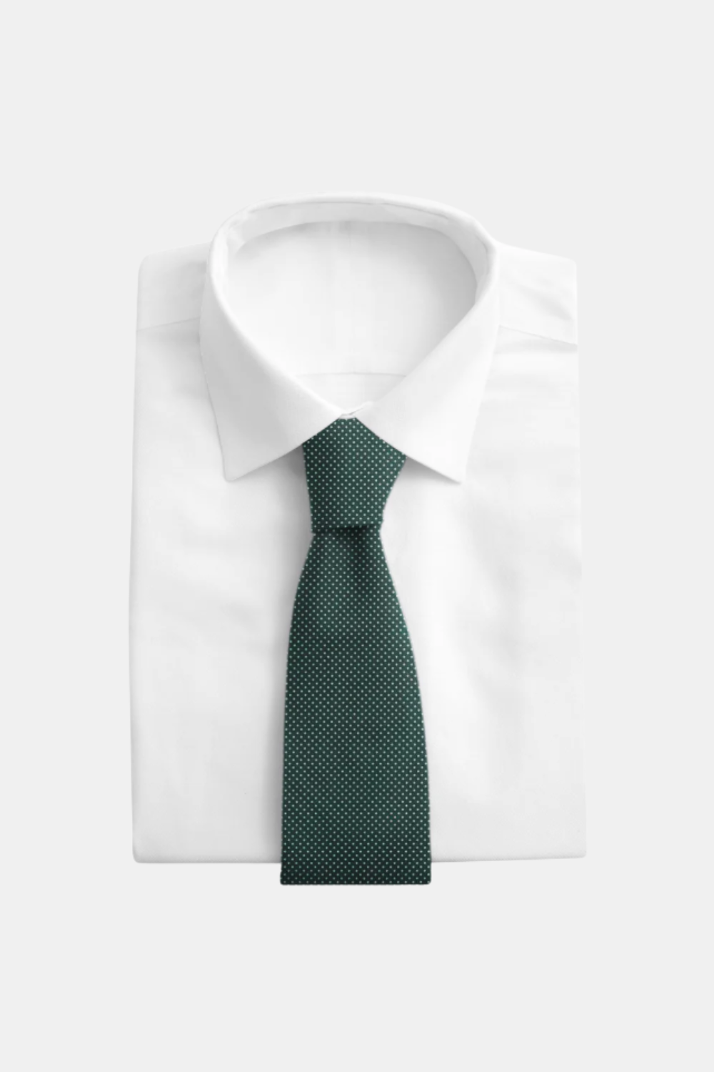 A dark green micro-patterned necktie neatly knotted and displayed on a folded white dress shirt against a light gray background.