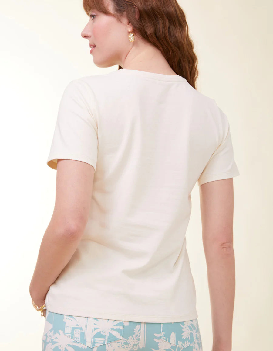 Woman wearing a white top with a light background