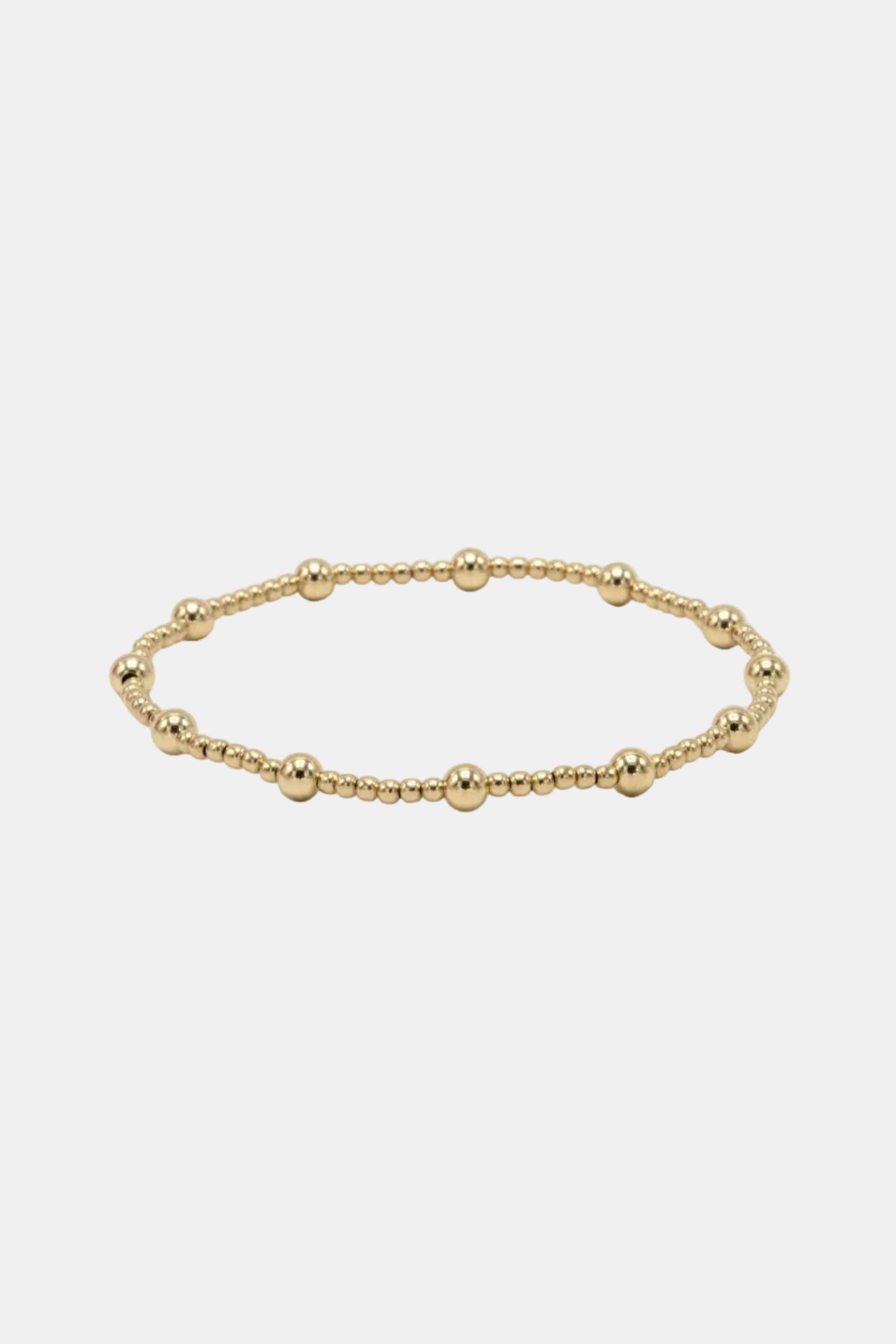 Gold beaded bracelet on a white background