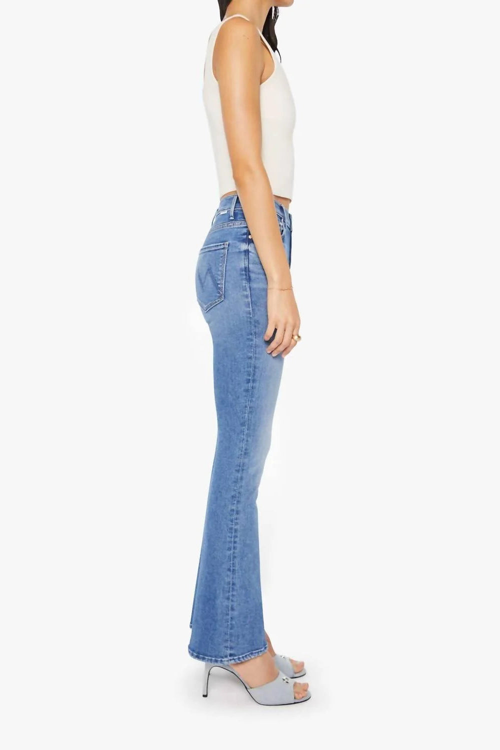 Woman wearing blue jeans on a white background