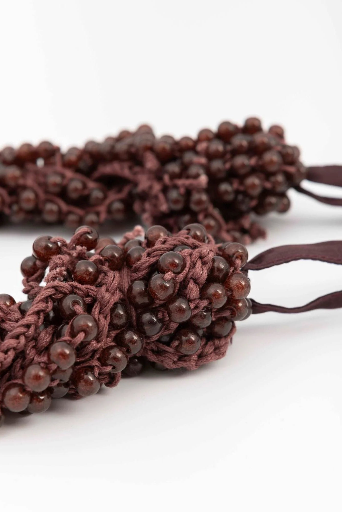 Brown beaded bracelet on a white background