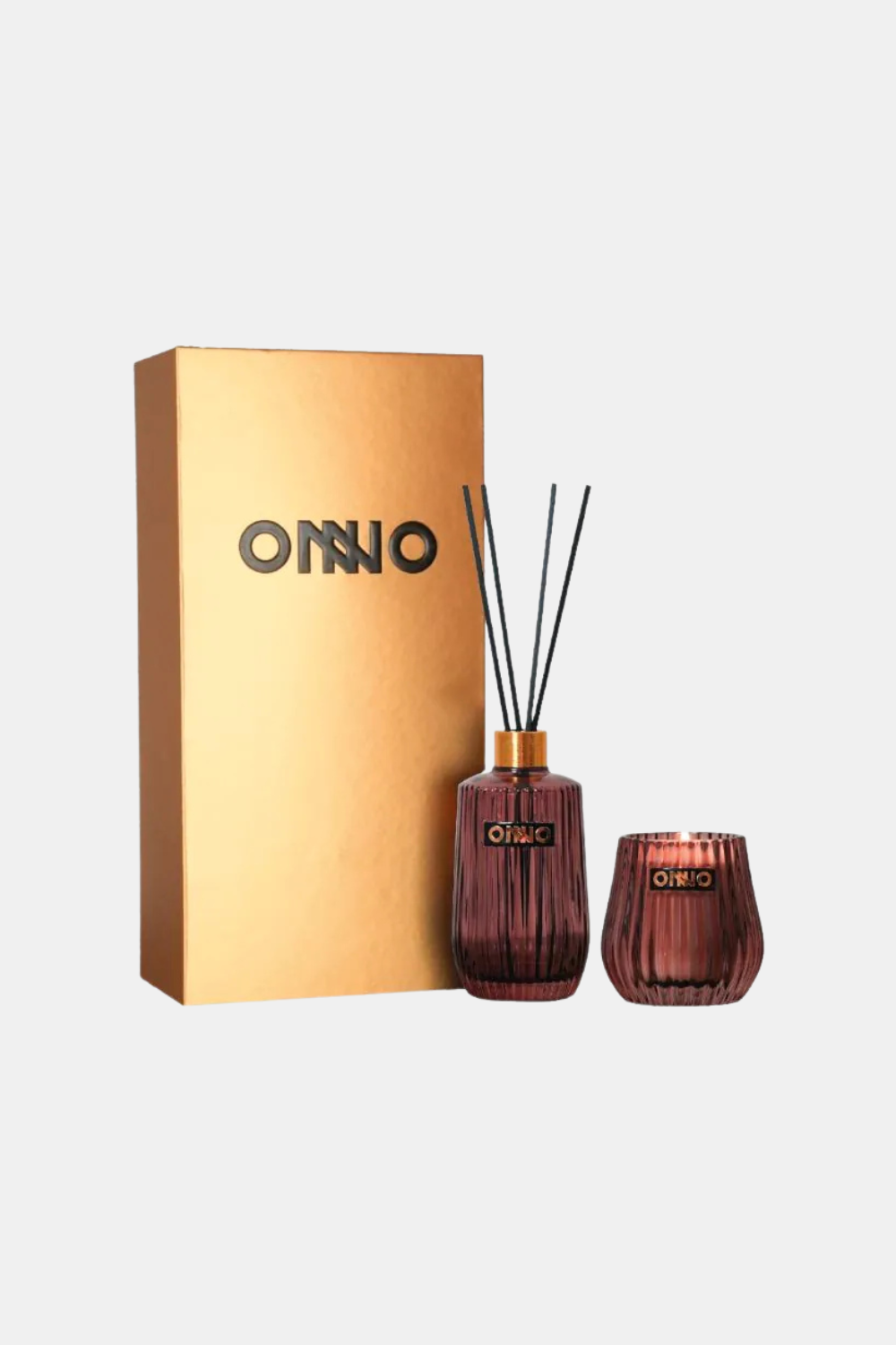 Onno reed diffuser and matching candle set with a metallic gold box on a light gray background.