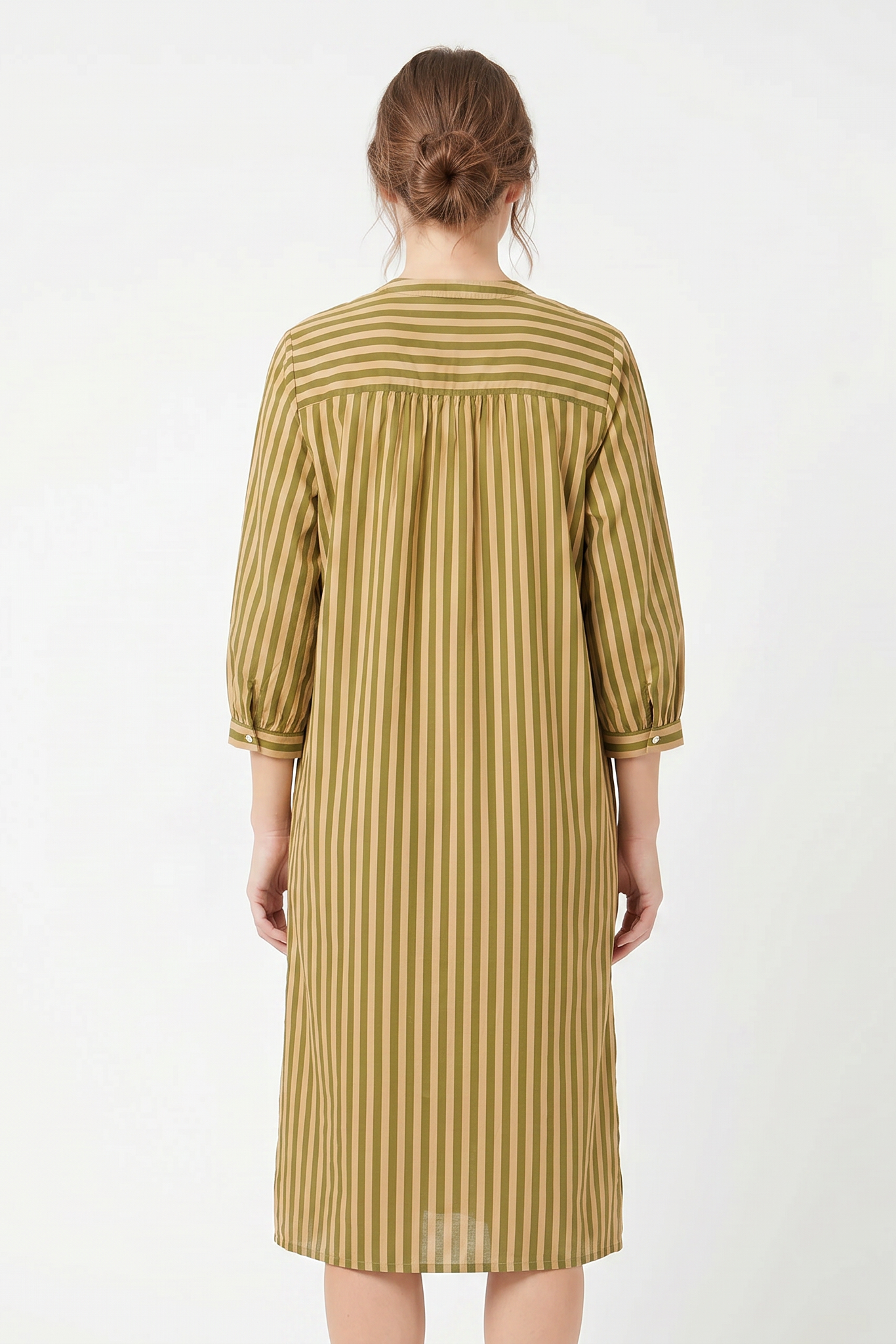 Woman wearing a striped dress on a white background