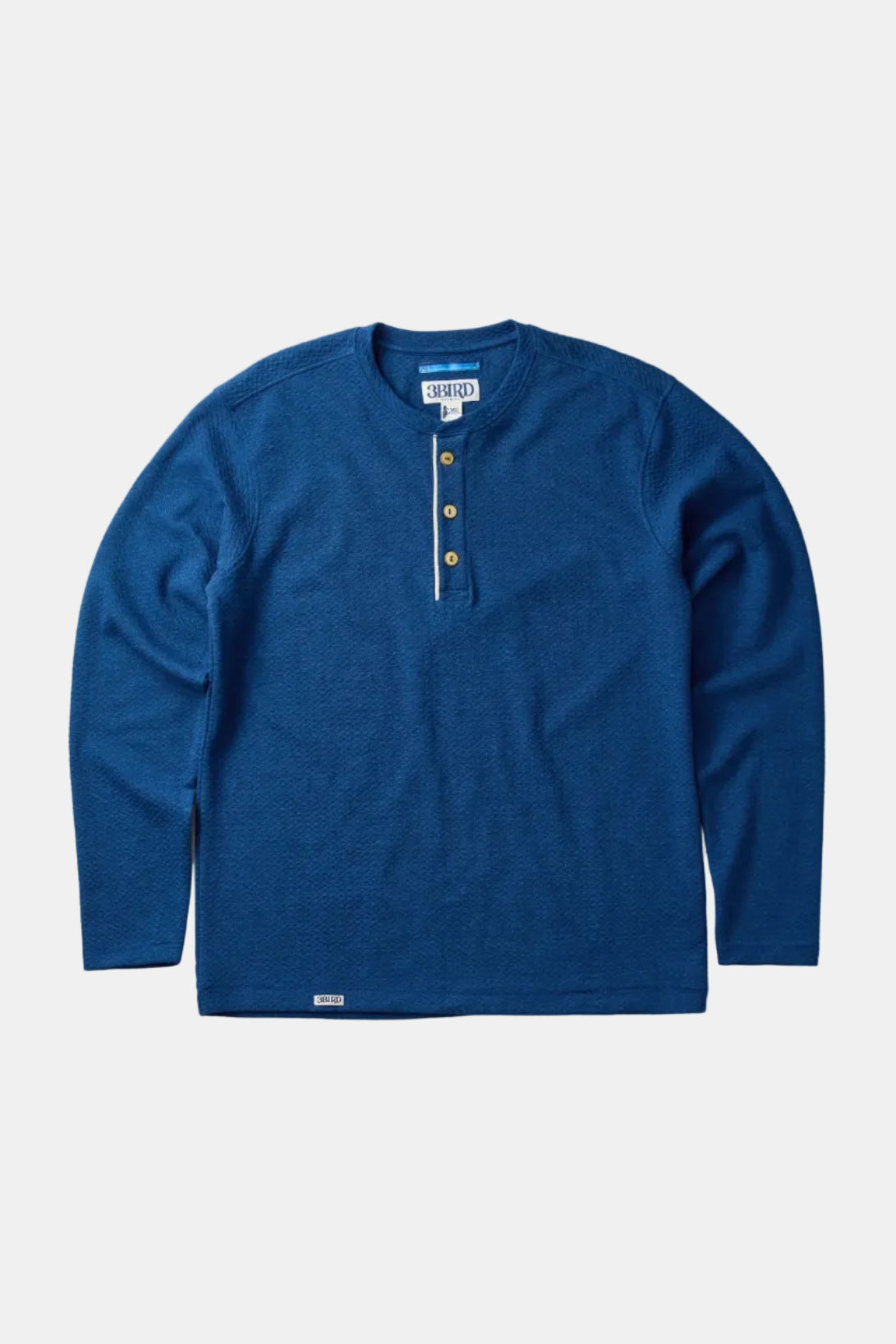 Blue long-sleeve shirt with button details on a light gray background