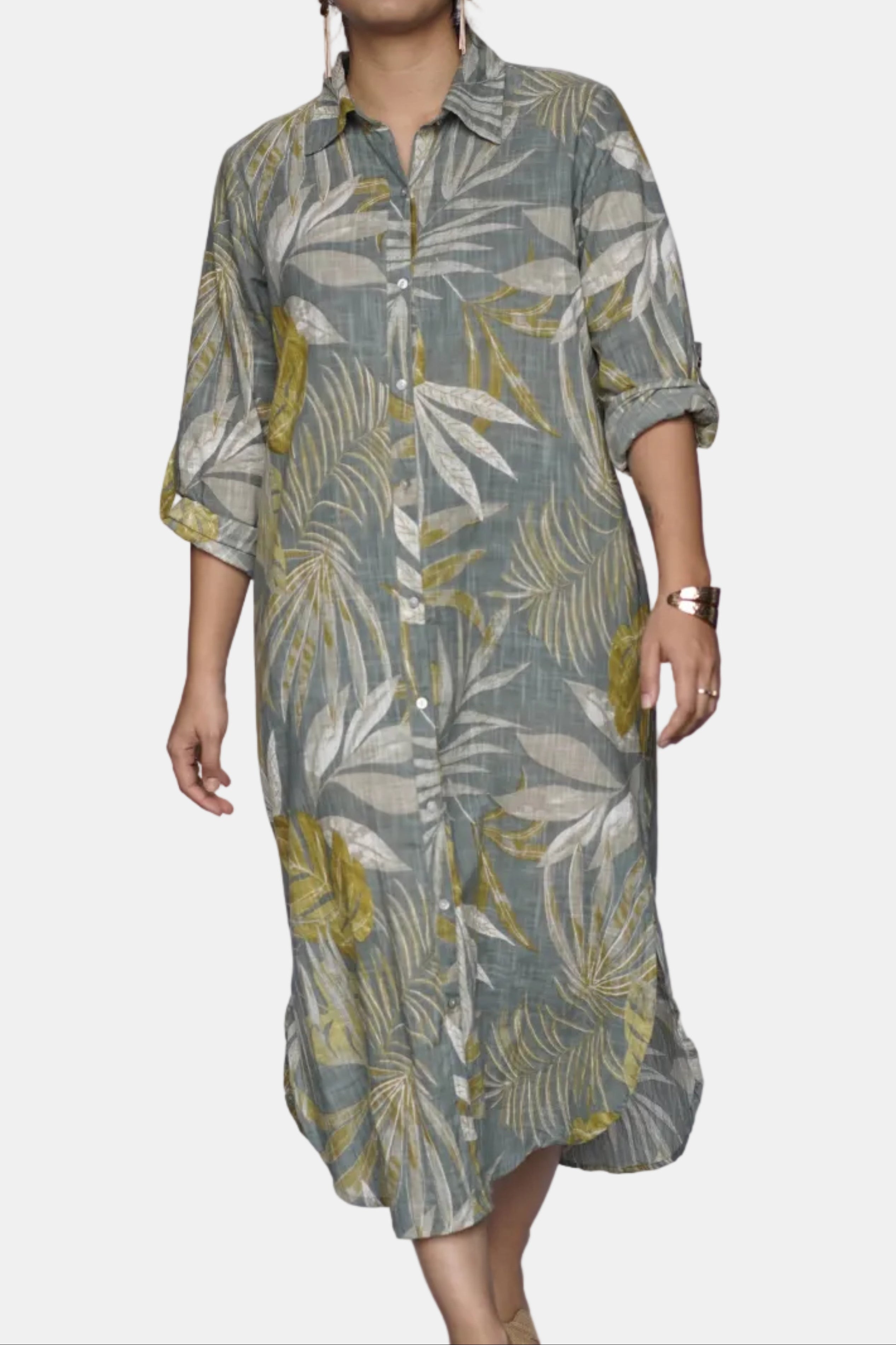 Woman wearing a green and yellow patterned dress against a white background