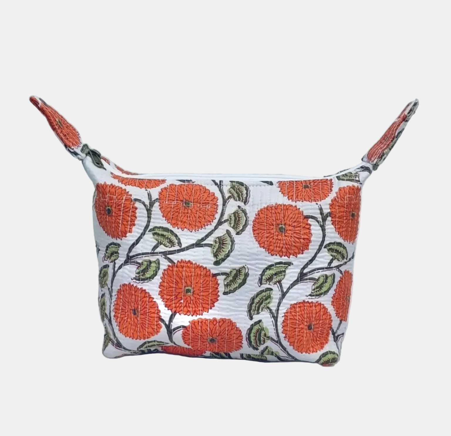 A small zippered pouch with a white background and an orange, green, and black floral pattern, featuring two small side loops, set against a light gray textured backdrop.