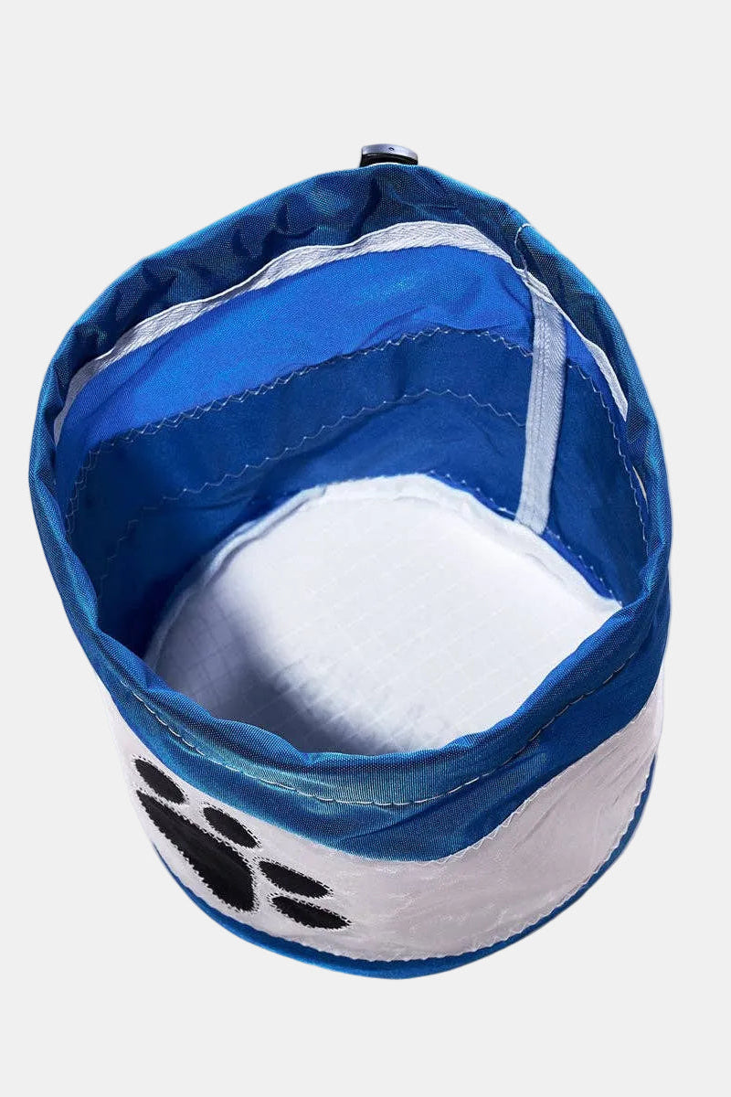 Blue and white pet bowl with paw print design on a white background