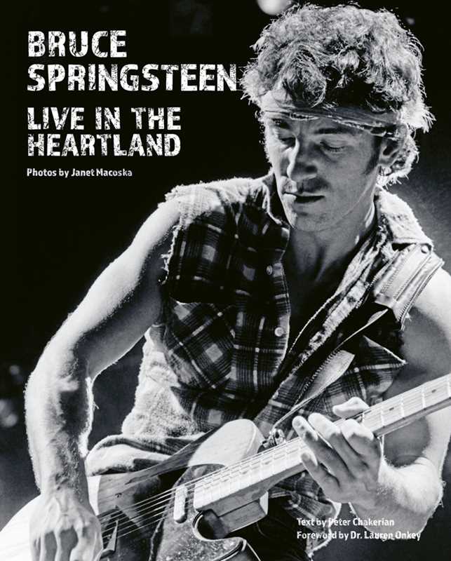 Black and white photo of Bruce Springsteen playing guitar with text 'Bruce Springsteen Live in the Heartland'.