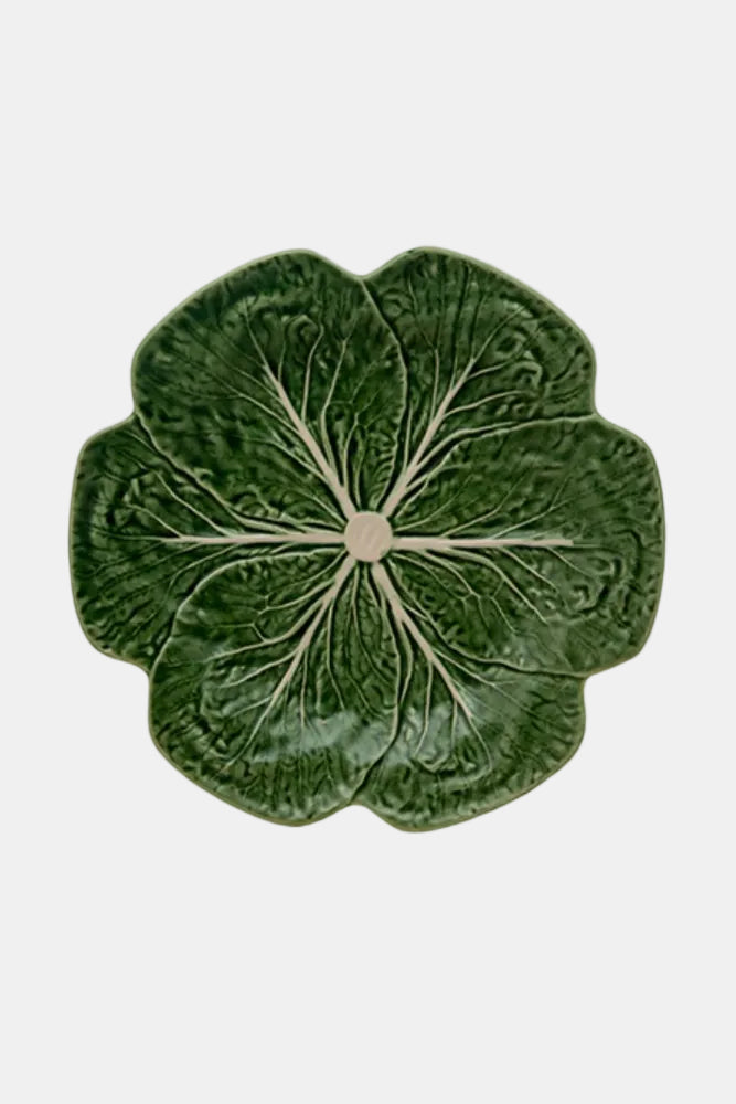 Green ceramic plate with leaf design on a white background