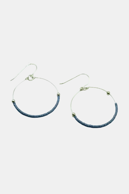 Hoop earrings with blue beads on a white background
