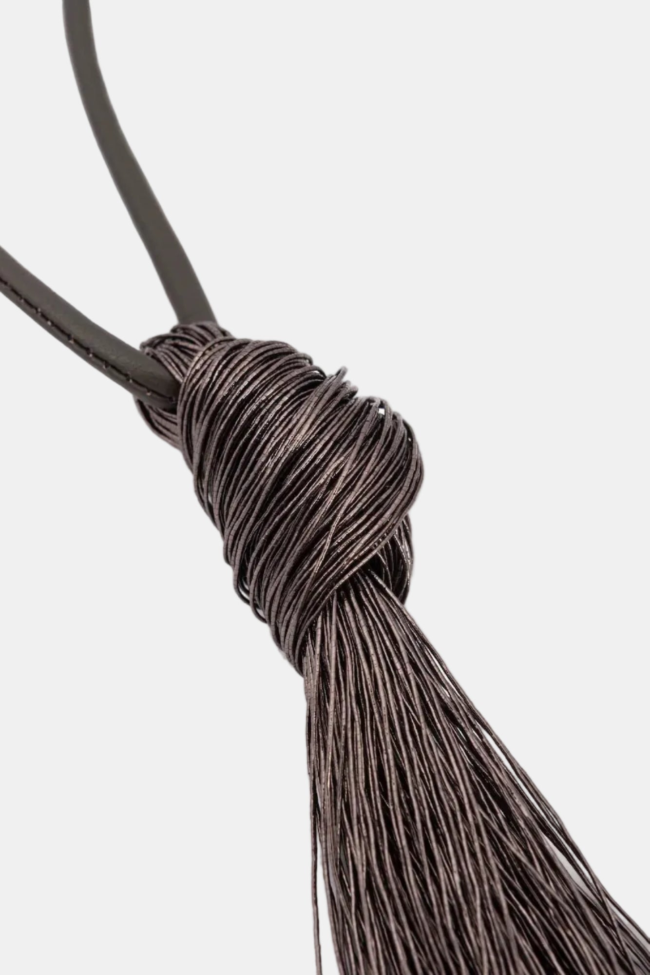 Close-up of a brown leather belt with a knot on a white background