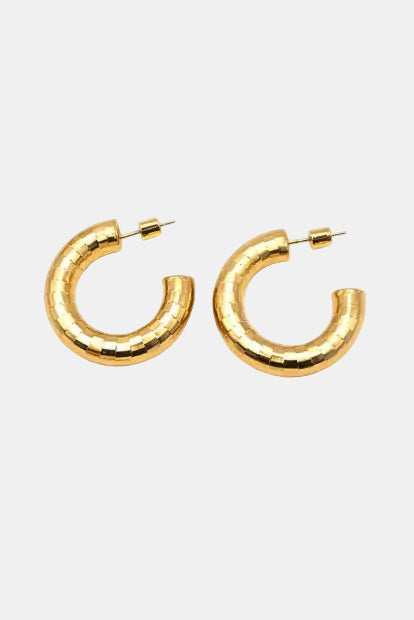 Gold hoop earrings on a white background