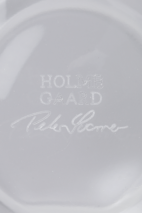 Close-up of a white ceramic plate with 'Hold On' and 'Peter Stone' text.