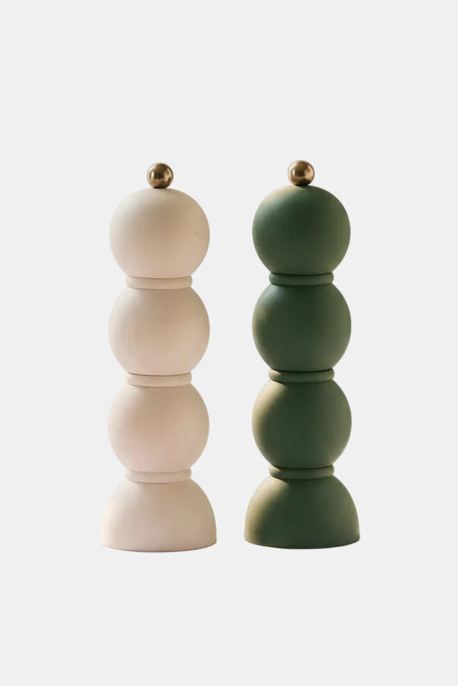 Two wooden salt and pepper shakers on a white background