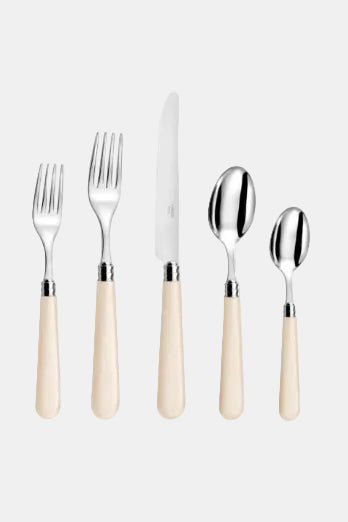 Set of silver cutlery with beige handles on a white background