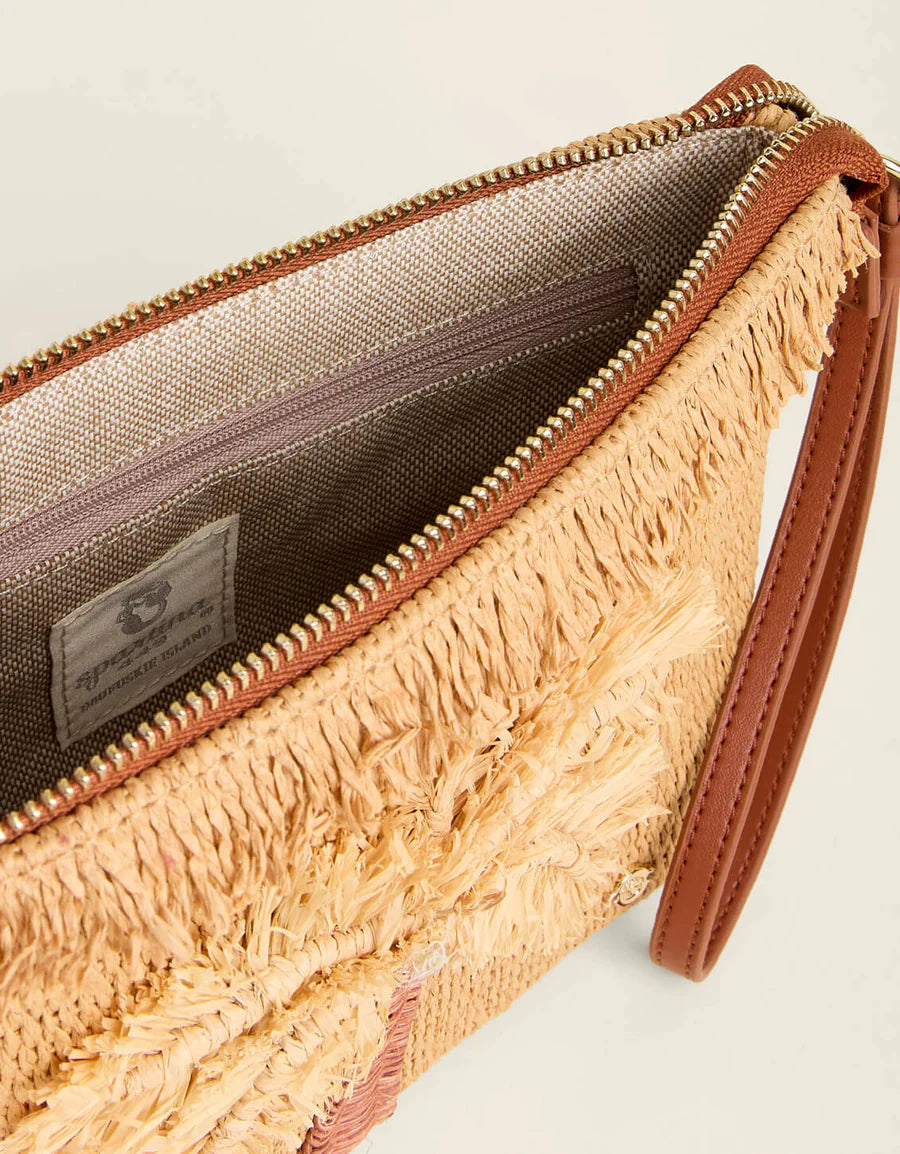 Close-up of a textured clutch bag with a visible brand label on a neutral background