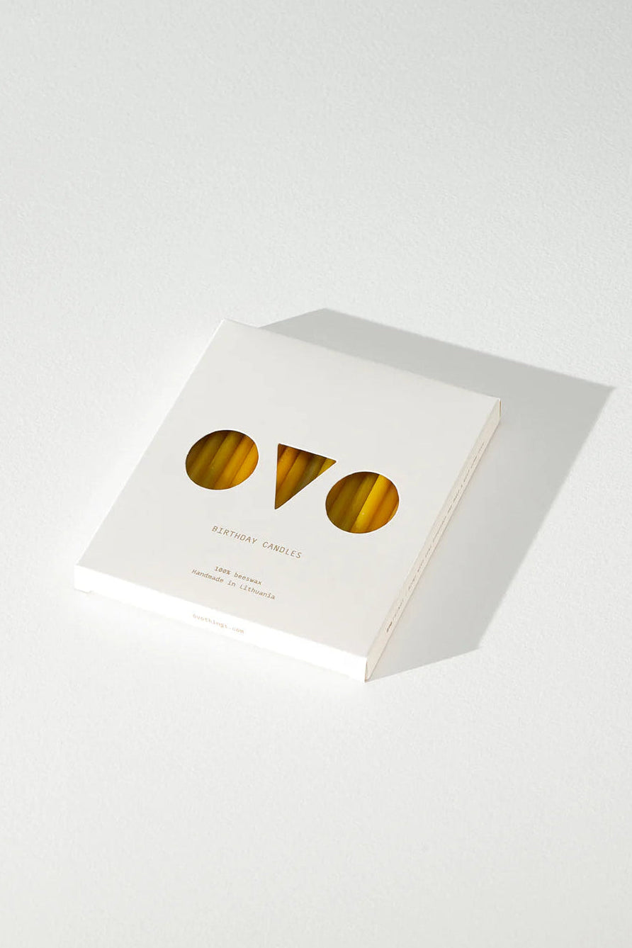 White box of beeswax candles with gold 'ovo' logo on a white background