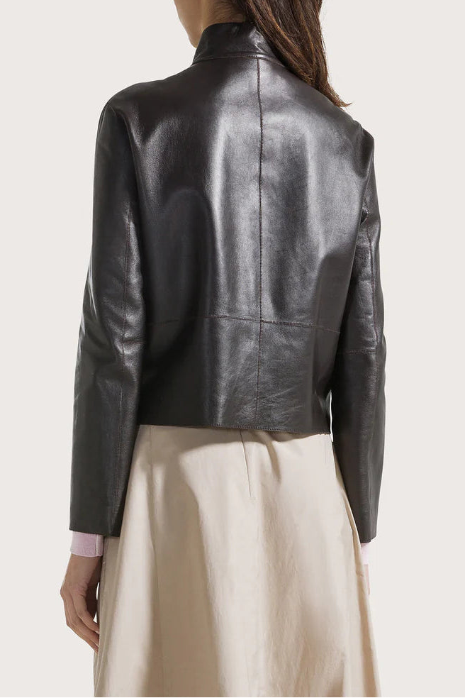 Person wearing a black leather jacket on a white background