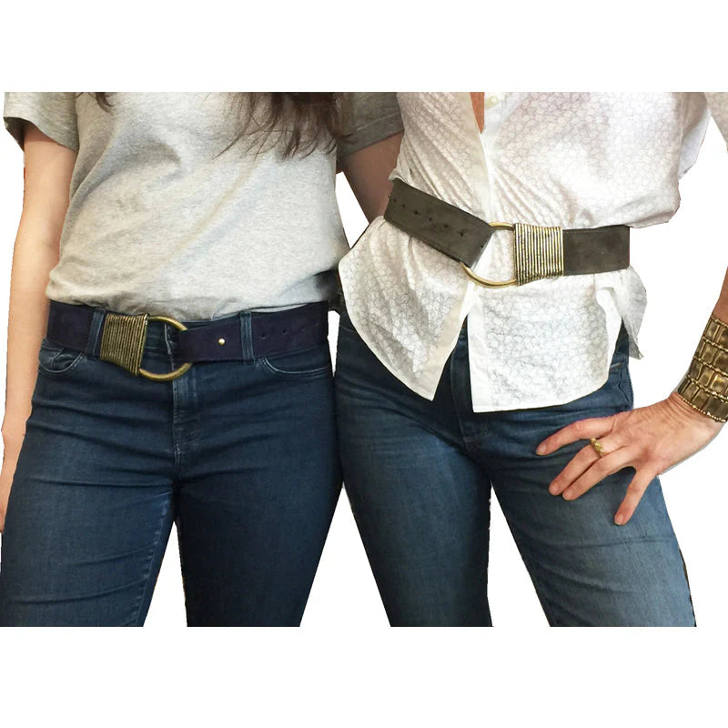 Two people wearing jeans with belts on a white background