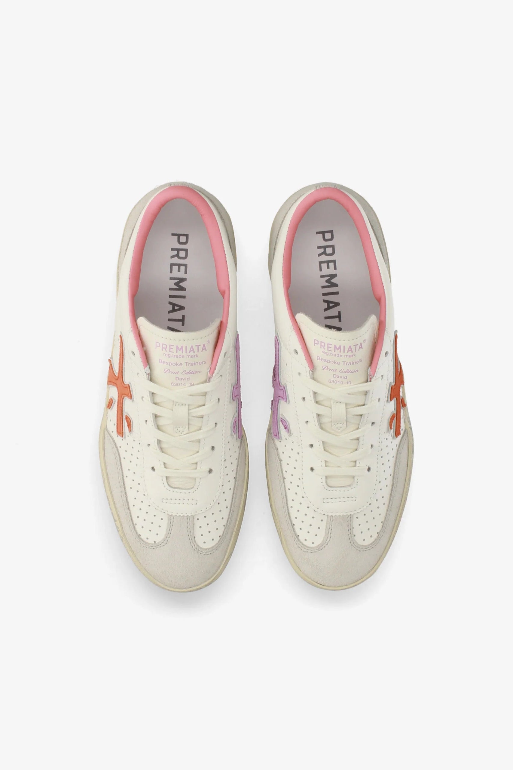 Pair of white sneakers with pink and orange accents on a white background