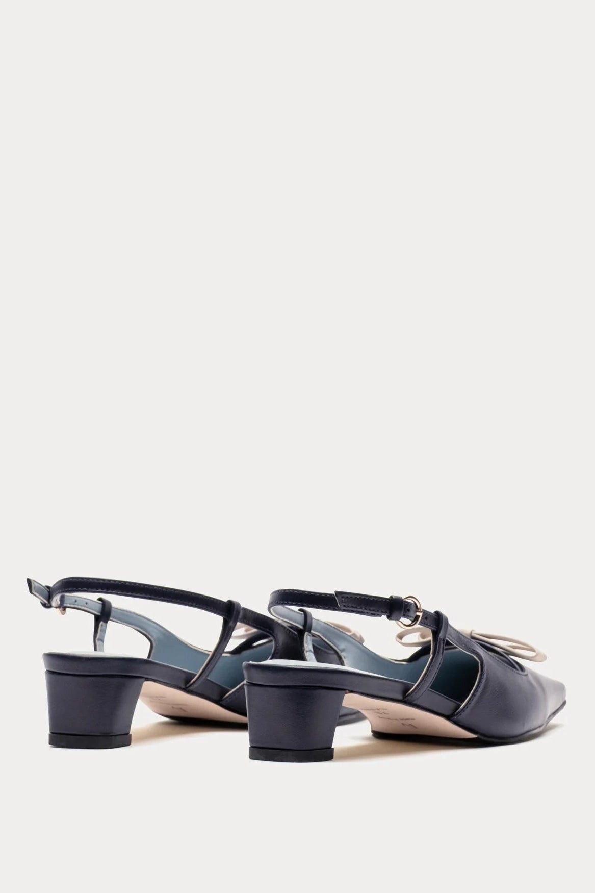 Pair of black high-heeled sandals on a light gray background