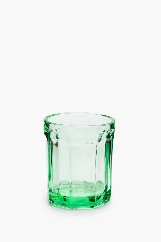 Green glass tumbler on a white background