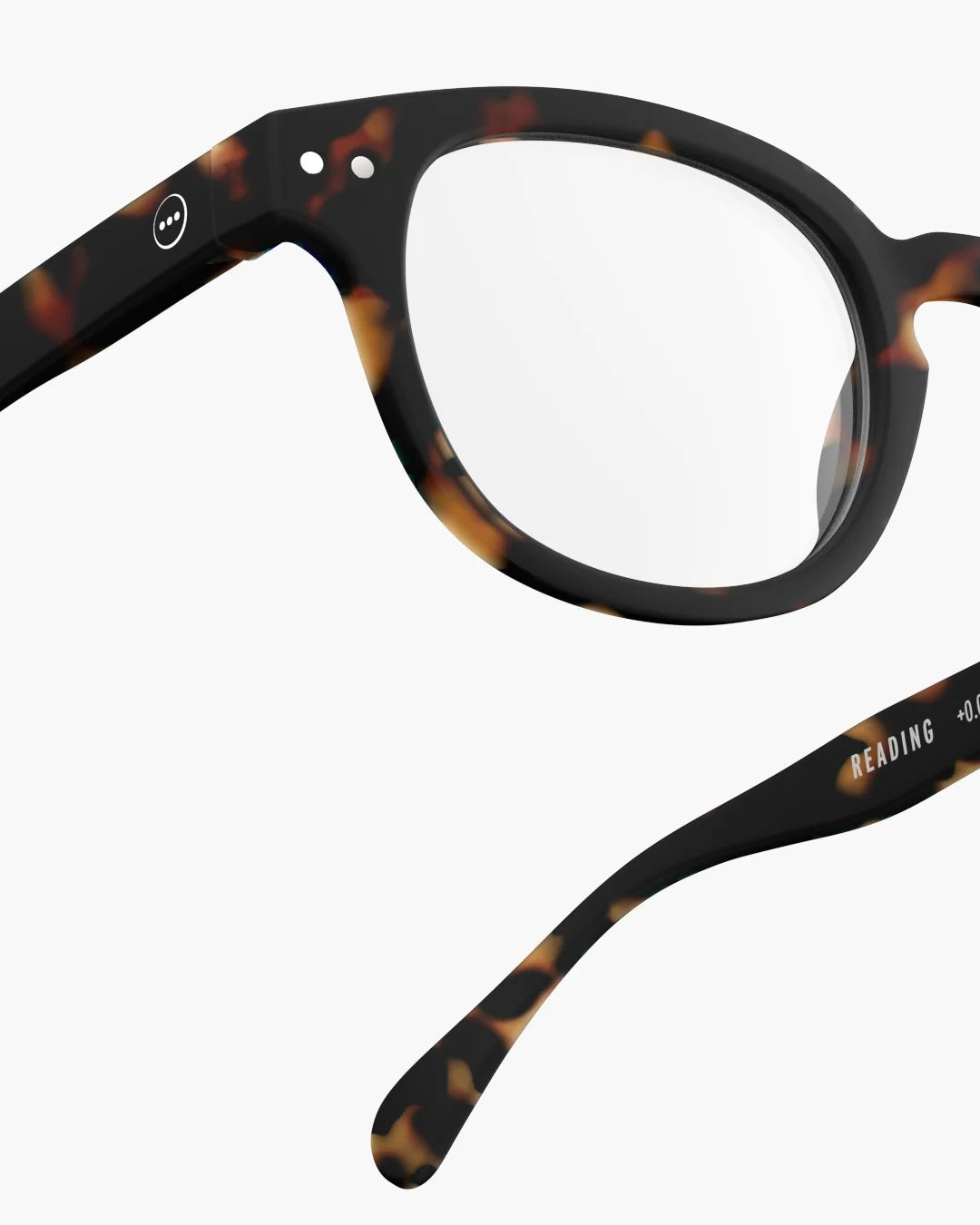 Tortoiseshell eyeglasses on a light gray background