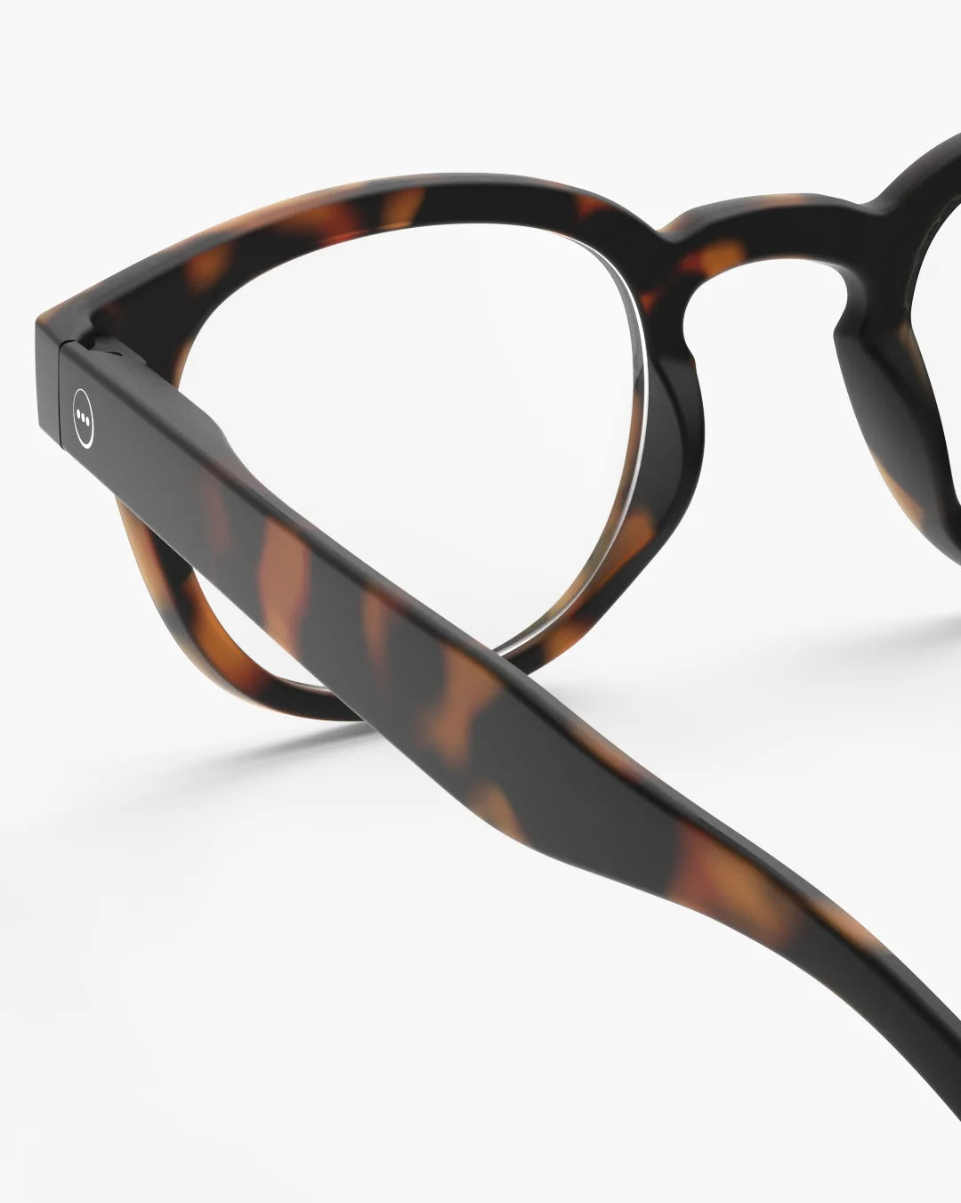 Close-up of tortoiseshell eyeglasses on a white background